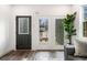 Elegant living room with a dark door with glass, modern French doors, and a tall Fiddle Leaf Fig at 2668 Brown Nw St, Atlanta, GA 30318