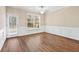 Bright dining area with hardwood floors, white wainscoting, a large window, and a door leading to the exterior at 3280 Cooper Woods Dr, Loganville, GA 30052