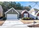 Lovely single-story home with green siding, brick accents, an attached garage, and a well-maintained front yard at 3280 Cooper Woods Dr, Loganville, GA 30052