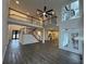 Open living space with high ceilings, a large fan, a staircase, and hardwood floors at 408 Midway Pt, Ellenwood, GA 30294