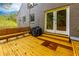 Inviting back deck features built-in bench seating, a grill, and access to the home via a set of double doors at 6596 Wright Rd, Atlanta, GA 30328