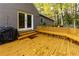 This back deck boasts built-in bench seating, an outdoor grill, and has backyard views at 6596 Wright Rd, Atlanta, GA 30328