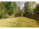 View of the backyard with bamboo accents and a wooden fence, offering ample privacy at 6596 Wright Rd, Atlanta, GA 30328