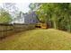 View of the expansive backyard and deck from the yard showcasing mature trees and privacy at 6596 Wright Rd, Atlanta, GA 30328