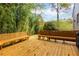 Backyard featuring a wood deck with two benches and surrounded by trees at 6596 Wright Rd, Atlanta, GA 30328