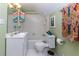 Charming bathroom with green walls, tile floor, white sink and bathtub, and colorful towels at 6596 Wright Rd, Atlanta, GA 30328