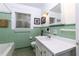 Quaint bathroom featuring vintage green tiling, a window for natural light, and classic fixtures at 6596 Wright Rd, Atlanta, GA 30328