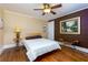 Comfortable bedroom with hardwood floors, ceiling fan, and ample space for relaxation and rest at 6596 Wright Rd, Atlanta, GA 30328