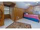 Bright bedroom with wood paneled walls, carpeting, two windows, and comfortable single bed at 6596 Wright Rd, Atlanta, GA 30328