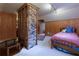 Comfortable bedroom featuring wood walls, brick partition, and a bed at 6596 Wright Rd, Atlanta, GA 30328