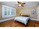 Cozy bedroom with hardwood floors, plantation shutters, and a ceiling fan for added comfort at 6596 Wright Rd, Atlanta, GA 30328