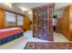 Comfortable bedroom featuring wood walls, brick partition, and cozy carpeting at 6596 Wright Rd, Atlanta, GA 30328