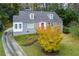 Inviting gray home with dormers and red door, set against a backdrop of autumn foliage at 6596 Wright Rd, Atlanta, GA 30328