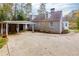 Grey house with an attached carport with a long driveway in front of the house at 6596 Wright Rd, Atlanta, GA 30328