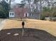 Quaint grey home with bright red door and dormer windows, nestled within a green lawn at 6596 Wright Rd, Atlanta, GA 30328