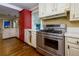 Kitchen with a stainless steel range, red cabinets, and hardwood flooring at 6596 Wright Rd, Atlanta, GA 30328