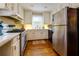 Spacious kitchen with white cabinets, stainless steel refrigerator and hardwood floors at 6596 Wright Rd, Atlanta, GA 30328