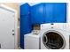Well-equipped laundry room with blue cabinets and washer and dryer units at 6596 Wright Rd, Atlanta, GA 30328