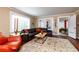 Comfortable living room showcasing a leather sofa, decorative rug, and bright natural light from large windows at 6596 Wright Rd, Atlanta, GA 30328