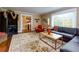 Spacious living room with large window, hardwood floors, dark entertainment center, and decorative area rug at 6596 Wright Rd, Atlanta, GA 30328