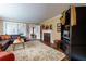 Cozy living room featuring a brick fireplace, plush seating, and a large area rug over hardwood floors at 6596 Wright Rd, Atlanta, GA 30328