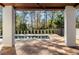 Covered outdoor living space with wood floors looks out onto a backyard pool at 1051 Wimberly Ne Rd, Brookhaven, GA 30319