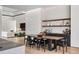 Open-concept dining area with a long wooden table, modern chairs, and bar area, adjacent to living room at 1051 Wimberly Ne Rd, Brookhaven, GA 30319