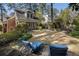 Serene backyard features a stone patio, lush greenery, a manicured lawn, and lounge chairs, perfect for relaxation at 1605 E Sussex Ne Rd, Atlanta, GA 30306