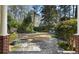 Inviting backyard space with stone patio, lush greenery, and a manicured lawn for relaxing or entertaining at 1605 E Sussex Ne Rd, Atlanta, GA 30306