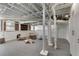 Spacious unfinished basement featuring exposed ceiling, painted pipes and ductwork, and carpeted floors at 1605 E Sussex Ne Rd, Atlanta, GA 30306