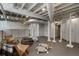 Unfinished basement area with exposed ceiling and ductwork, featuring seating at 1605 E Sussex Ne Rd, Atlanta, GA 30306