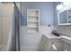 Charming bathroom features a vanity, patterned tile flooring, and tub with shower at 1605 E Sussex Ne Rd, Atlanta, GA 30306