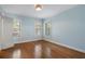 Cozy bedroom showcasing hardwood floors, light blue walls, and natural lighting at 1605 E Sussex Ne Rd, Atlanta, GA 30306