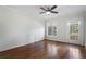 Bright bedroom featuring hardwood floors, a ceiling fan, window and door to the outside at 1605 E Sussex Ne Rd, Atlanta, GA 30306