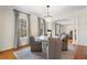 Bright dining room with a chandelier, round table, gray chairs, and an archway that leads to other spaces at 1605 E Sussex Ne Rd, Atlanta, GA 30306