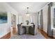 Bright dining room with a chandelier, round table, gray chairs, and a window offering a view of the outdoors at 1605 E Sussex Ne Rd, Atlanta, GA 30306