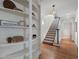 Elegant foyer with hardwood floors, built-in bookshelves, and a staircase leading to the upper level at 1605 E Sussex Ne Rd, Atlanta, GA 30306