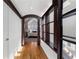 Hallway with wood floors, trimmed doorway, and windows overlooking a serene bedroom retreat at 1605 E Sussex Ne Rd, Atlanta, GA 30306