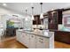 Kitchen island with granite countertop, undermount sink and barstool seating overlooking a dining space at 1605 E Sussex Ne Rd, Atlanta, GA 30306