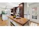 Gourmet kitchen featuring a butcher block island, custom cabinetry and wine cooler at 1605 E Sussex Ne Rd, Atlanta, GA 30306