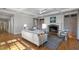 Sunlit living room features a cozy fireplace, coffered ceiling and hardwood floors at 1605 E Sussex Ne Rd, Atlanta, GA 30306