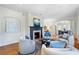 Bright living room with hardwood floors, fireplace, elegant furniture, and archways that lead to the dining area at 1605 E Sussex Ne Rd, Atlanta, GA 30306