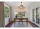 Home office featuring a chandelier, neutral-toned walls, curtains, and a large window overlooking lush greenery at 1605 E Sussex Ne Rd, Atlanta, GA 30306