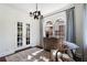 Charming sitting area featuring french doors, neutral color palette, vintage chandelier and views of the outside at 1605 E Sussex Ne Rd, Atlanta, GA 30306