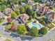 Aerial view of the community clubhouse and swimming pool surrounded by trees at 1965 Carlotta Ct, Atlanta, GA 30345