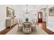 Formal dining room showcasing a glass-top table, chandelier, and wainscoting at 1965 Carlotta Ct, Atlanta, GA 30345