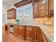 Well-lit kitchen features wood cabinets, granite countertops, and modern stainless steel dishwasher at 1965 Carlotta Ct, Atlanta, GA 30345