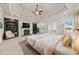 Luxurious primary bedroom with a trey ceiling, a fireplace, built-in bookshelves, and French doors leading to a balcony at 1965 Carlotta Ct, Atlanta, GA 30345