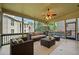 Enclosed sunroom featuring wicker furniture and tile floor overlooking the backyard at 1965 Carlotta Ct, Atlanta, GA 30345