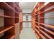 Spacious walk-in closet with custom wood shelving, drawers, and ample storage space for clothing and accessories at 1965 Carlotta Ct, Atlanta, GA 30345